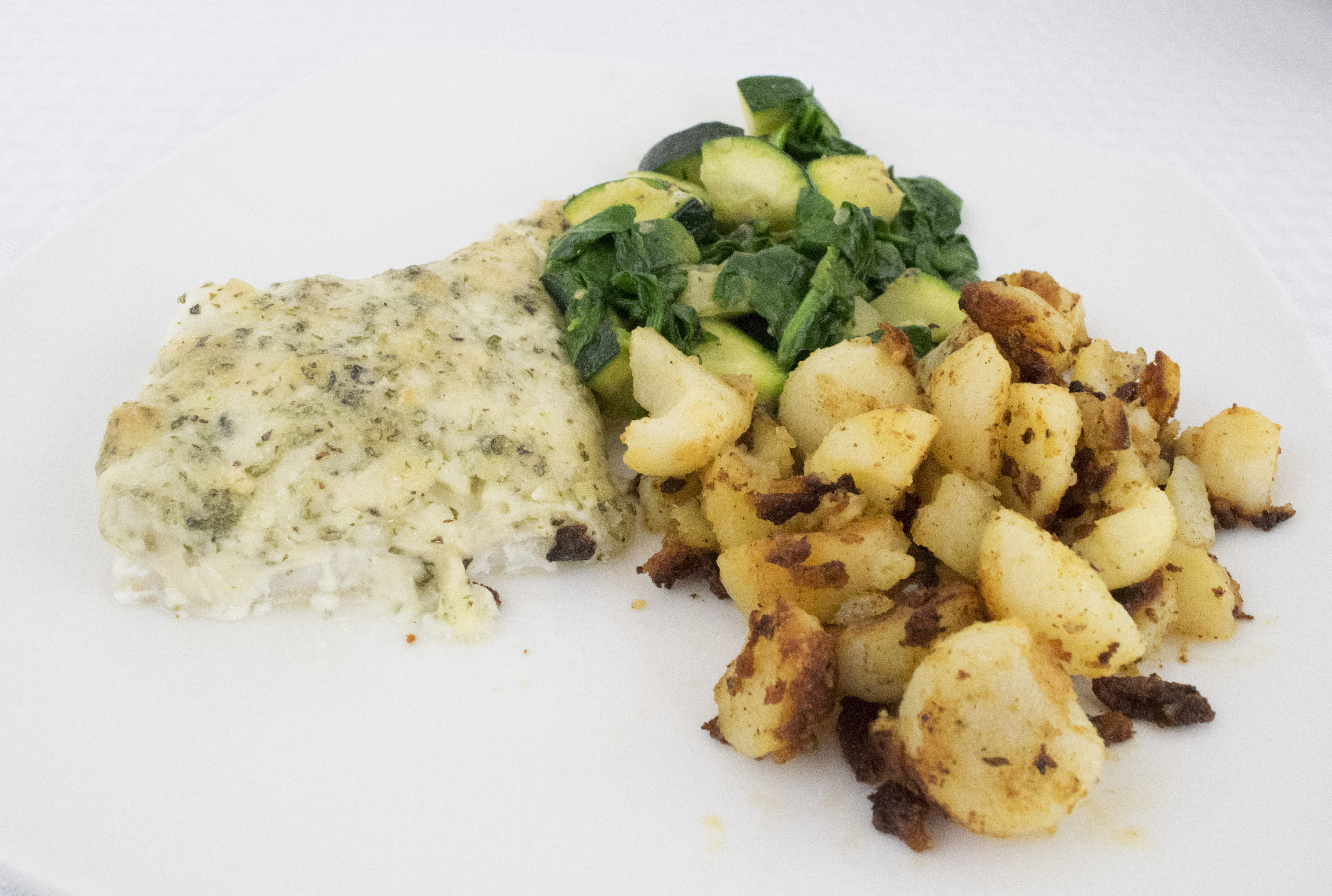 Cod with potatoes and zucchini and spinach